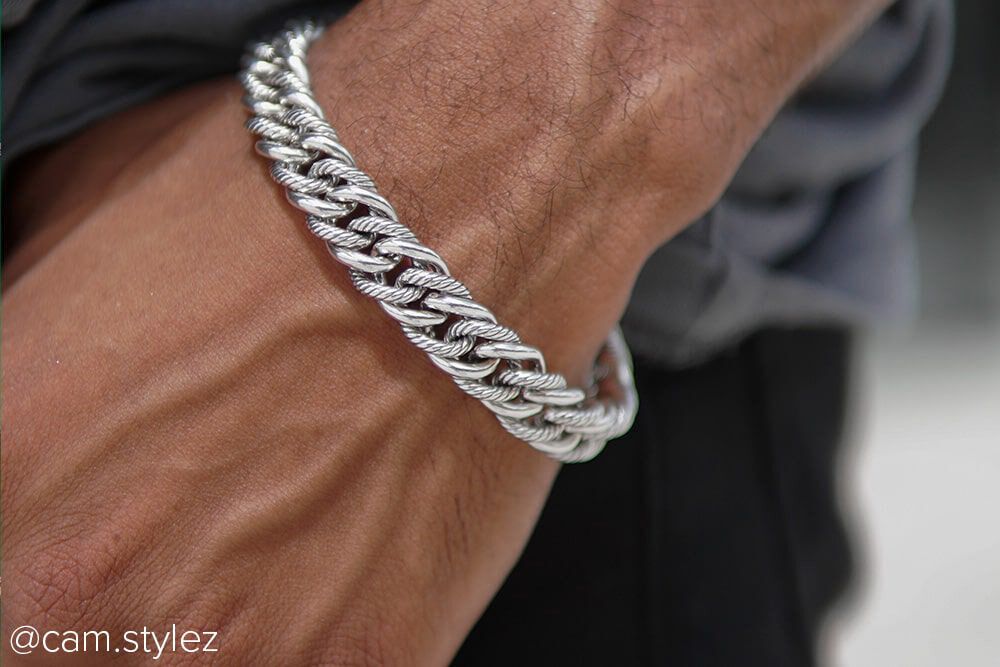 Model wearing a stainless steel curb bracelet crafted for men in mind.