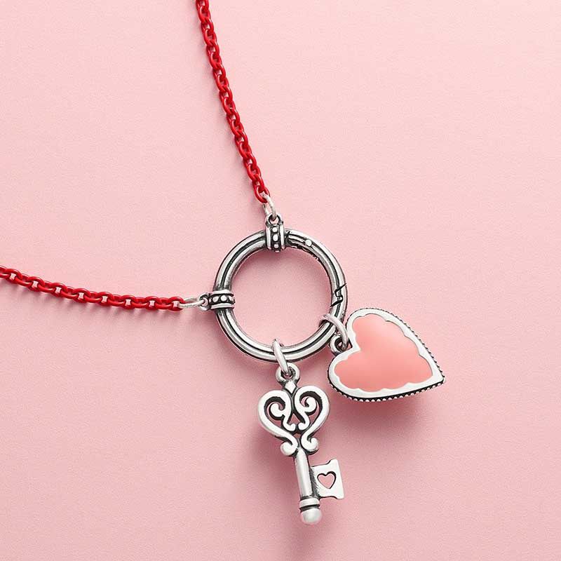Changeable charm holder with heart and key charms.