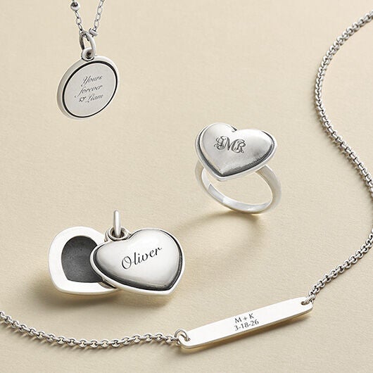 Engraved charms and necklaces in silver and gold