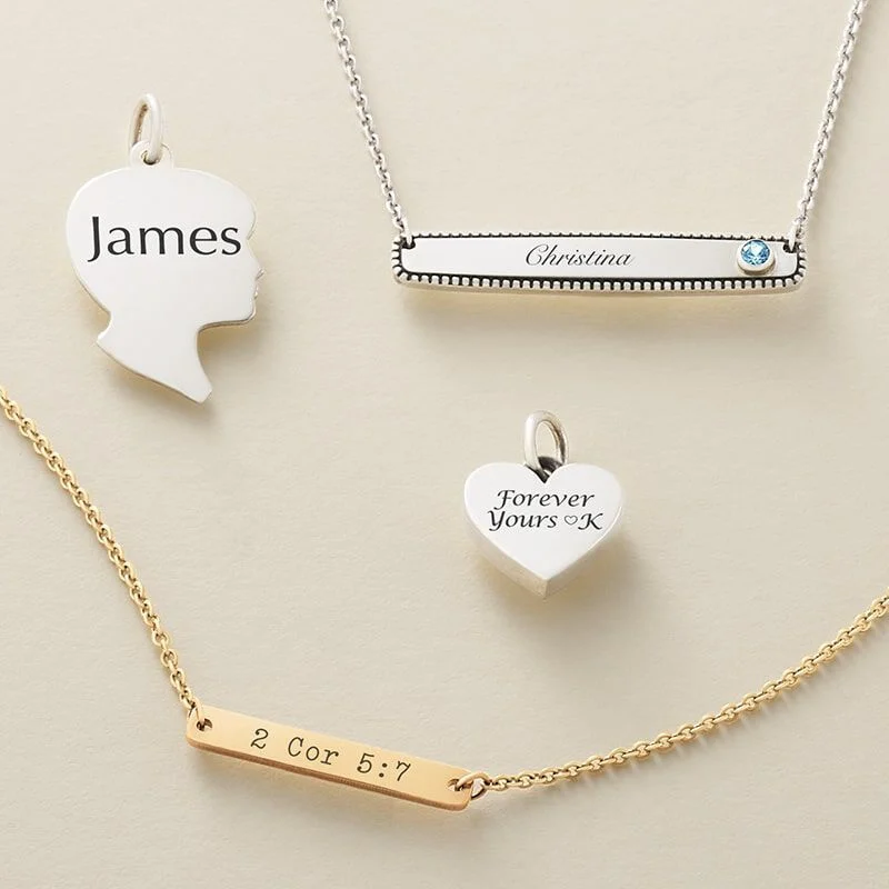 Engraved charms and necklaces in silver and gold