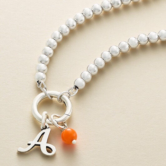 Changeable charm holder with initial charm and colorful accent bead