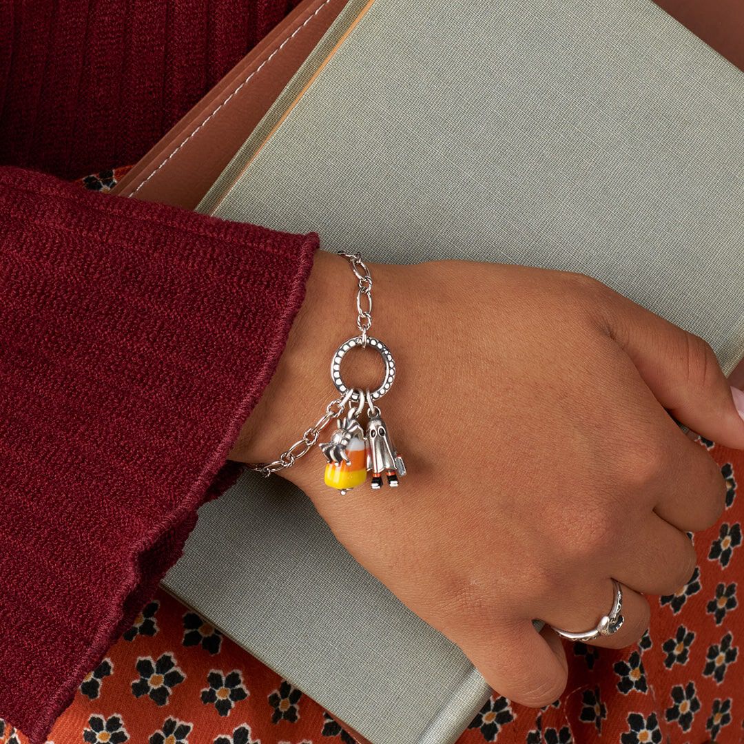 Woman wearing a Halloween-themed charm bracelet