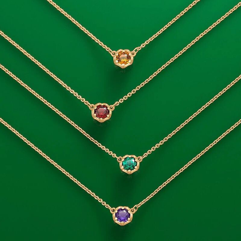 Four 14K gold Cherished Birthstone Necklace layered and available in a variety of birthstones.