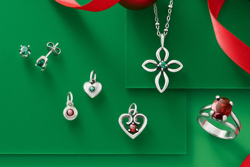 An assortment of sterling silver gemstone jewelry in a variety of gems including emeralds, garnet and rubies.