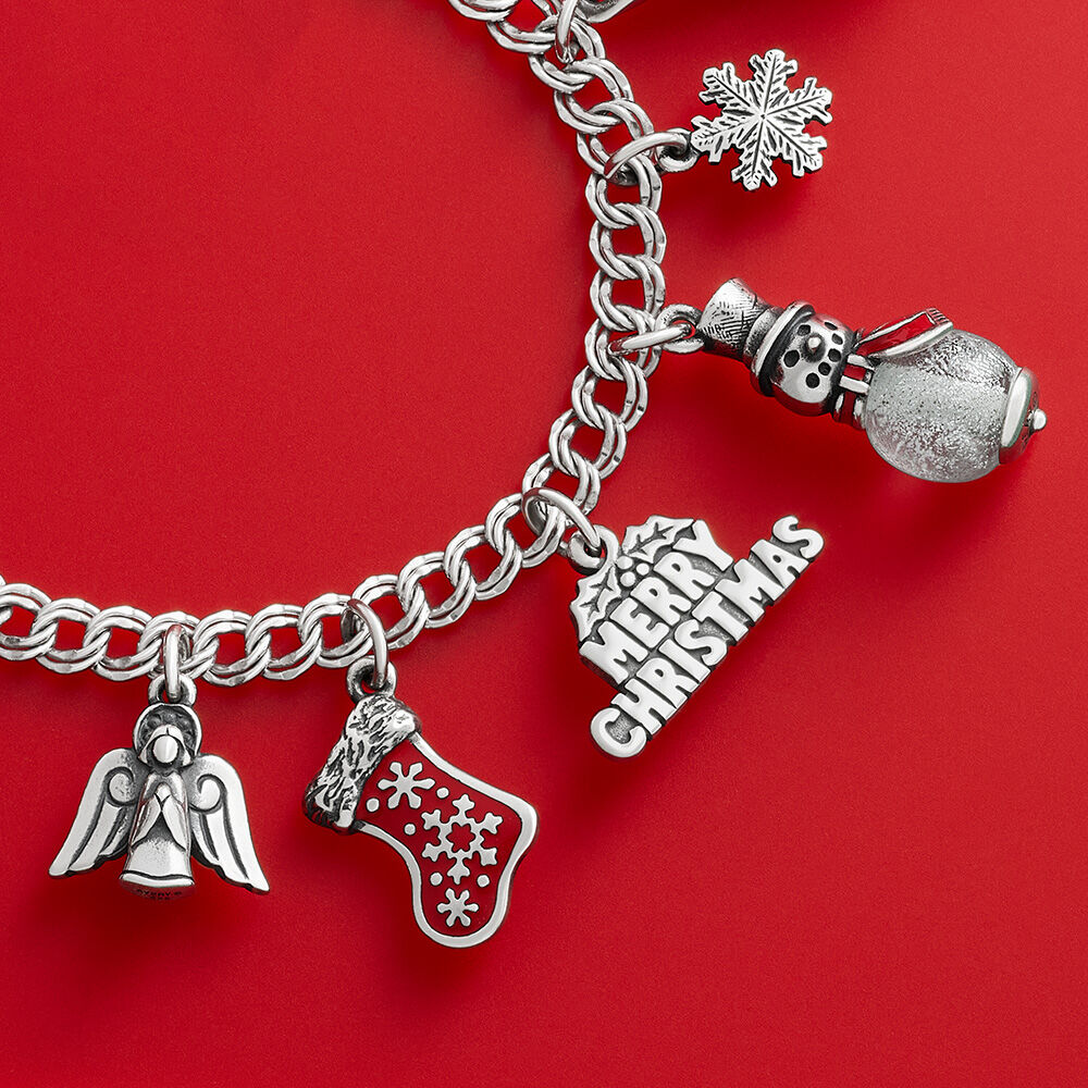 Five Christmas charms in sterling silver or enamel on a sterling silver charm bracelet.