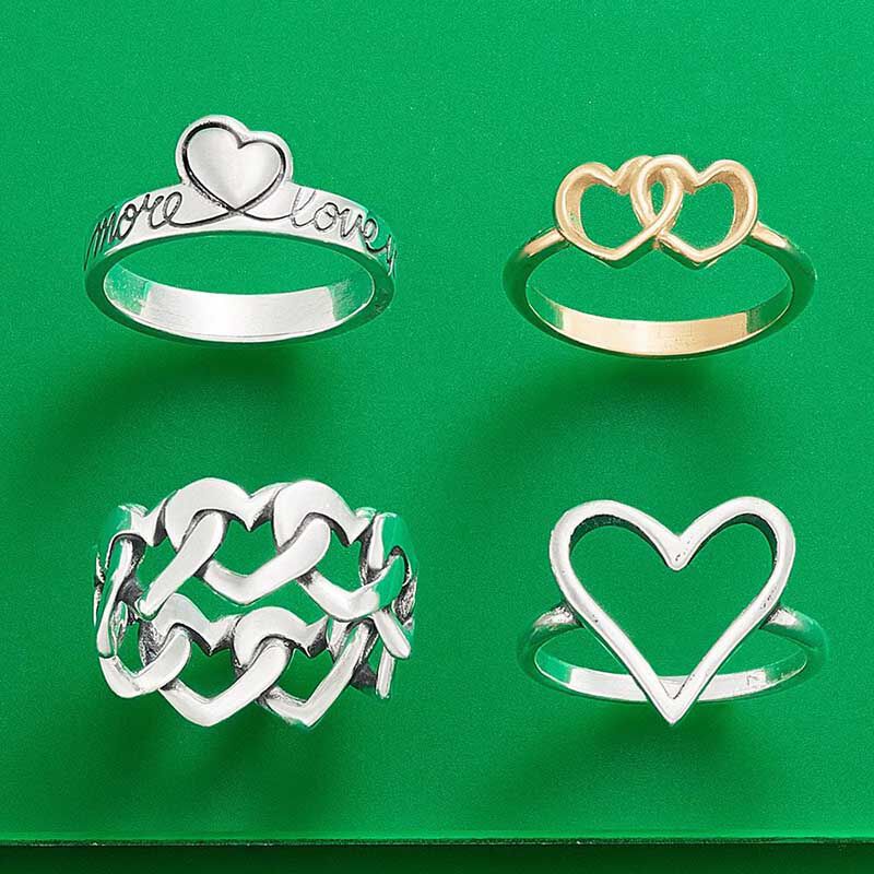 Three sterling silver heart rings and one 14K gold heart ring
