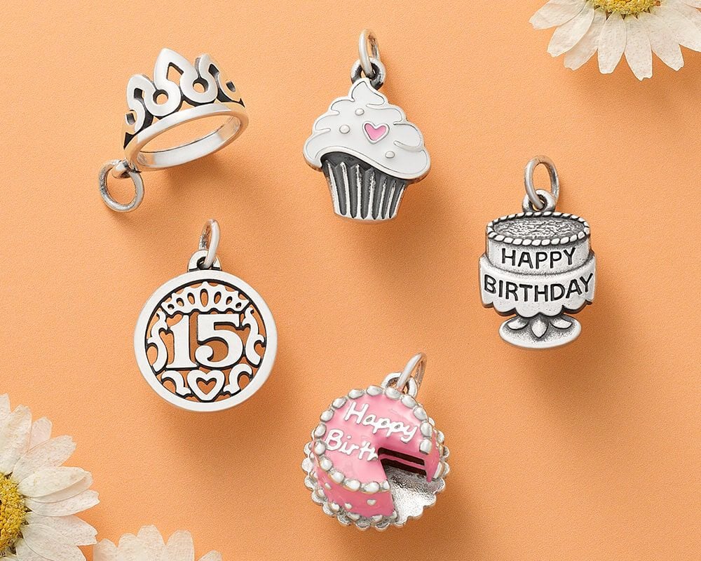 Sterling silver and enameled birthday-themed charms.