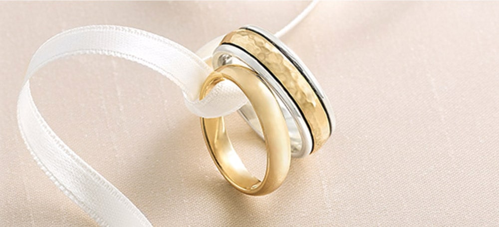 James Avery Wedding Rings tied together with a ribbon