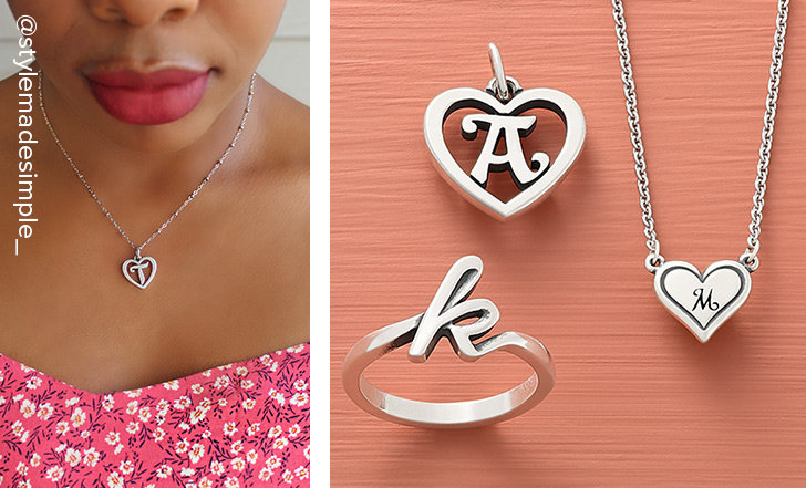 Woman wearing the sterling silver Heart Script Initial Charm on a Forged Beaded Chain. An assortment of letter designs in a variety of styles including charms, rings and necklaces.