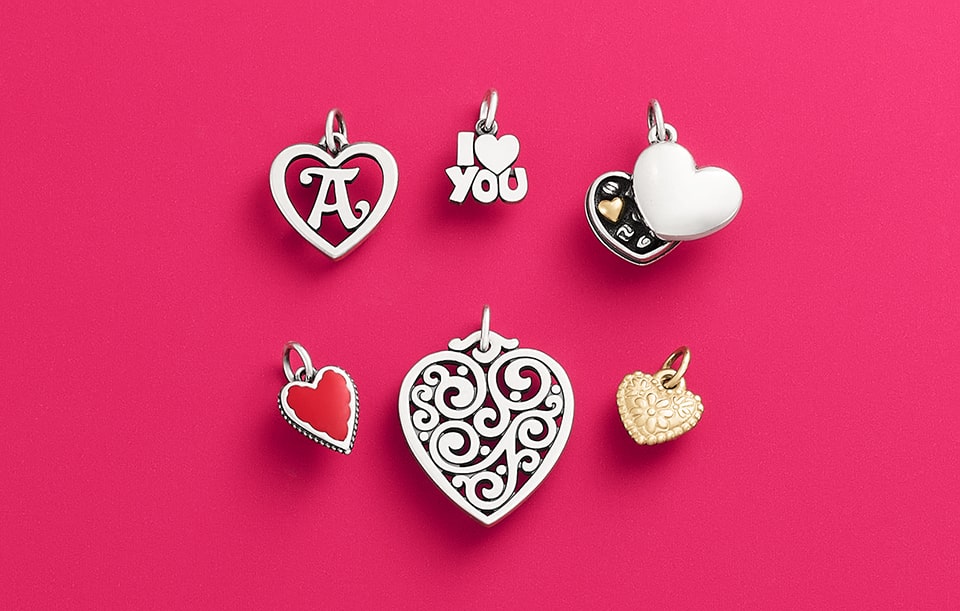 Heart charms with initials and scrolls in sterling silver and gold.